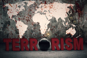 Terrorism concept: Text of terrorism with a bomb and bloody world map background