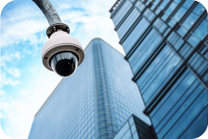 Dome surveillance camera installed outside a high-rise commercial building, representing urban security solutions by American Security Force.