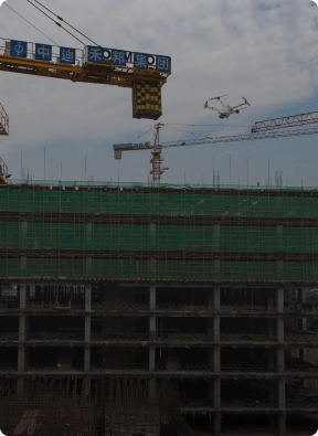 Security drone conducting aerial surveillance over a high-rise construction site, showcasing American Security Force's monitoring solutions.
