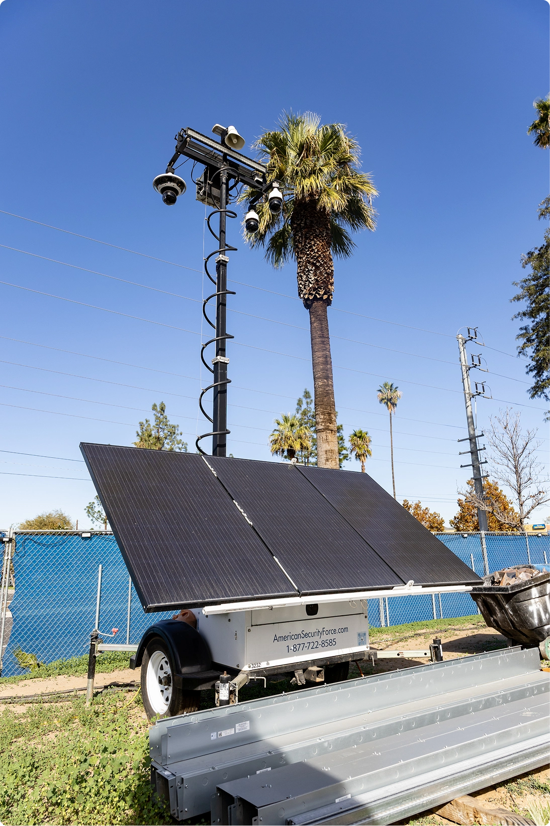 Solar-powered mobile surveillance trailer with security cameras and solar panels used for remote site monitoring in California