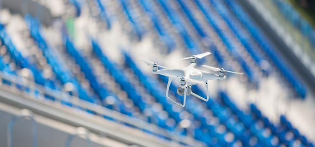 drone flies over a stadium