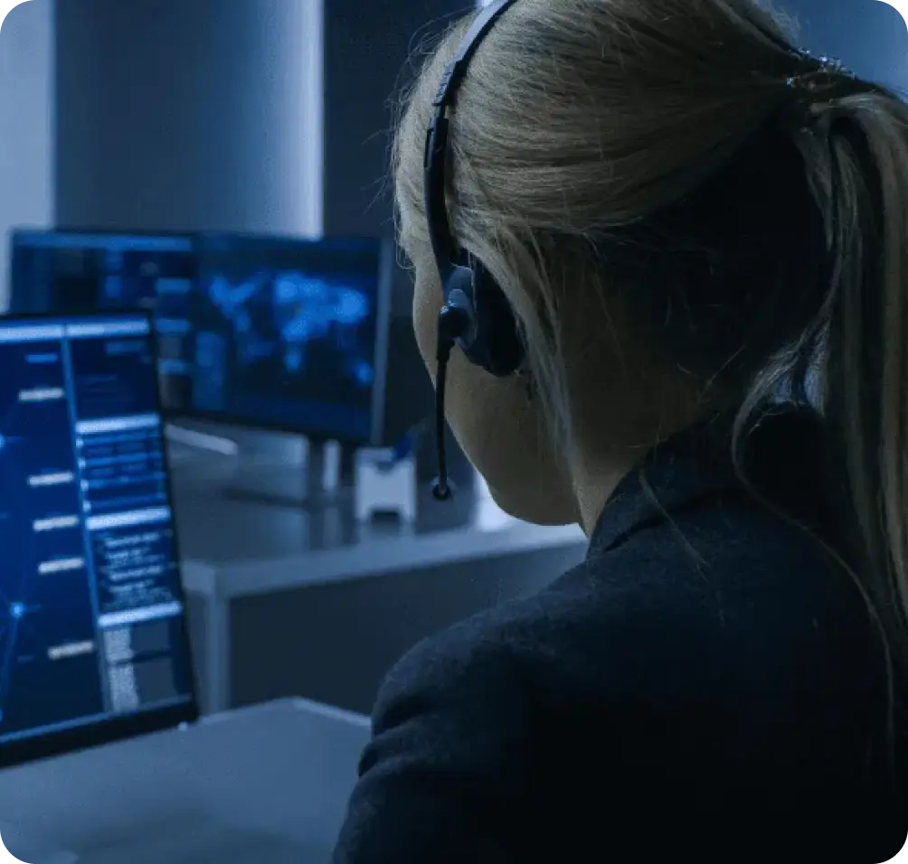 Expert Monitoring at a Security Response Center for 24/7 Protection Security specialist monitoring live feeds and coordinating responses in a professional security response center.