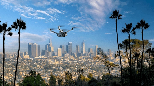 Surveillance drone from American Security Force flying above Los Angeles skyline, providing aerial security coverage over the city.