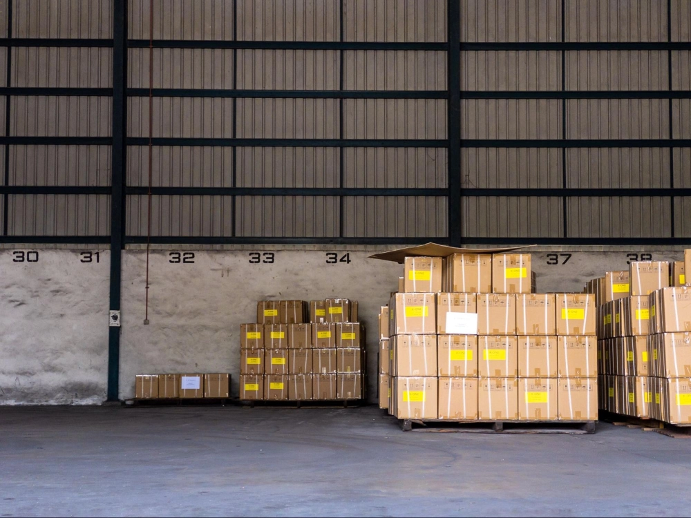 Pallets of boxed goods organized in a secure warehouse storage facility protected by American Security Force's warehouse security solutions