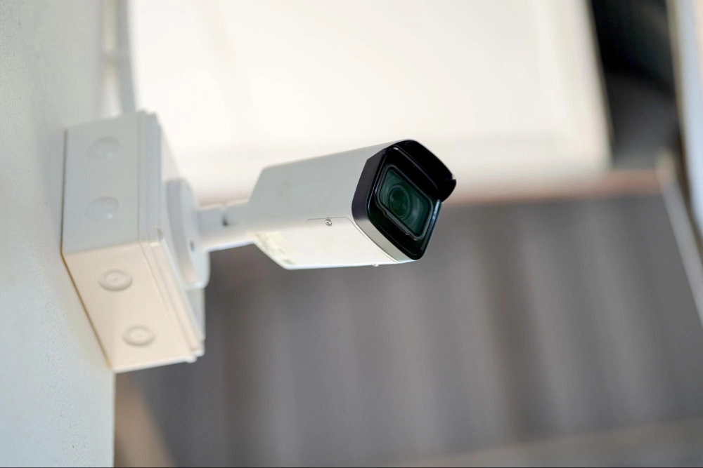 Close-up of a mounted surveillance camera providing 24/7 warehouse security by American Security Force