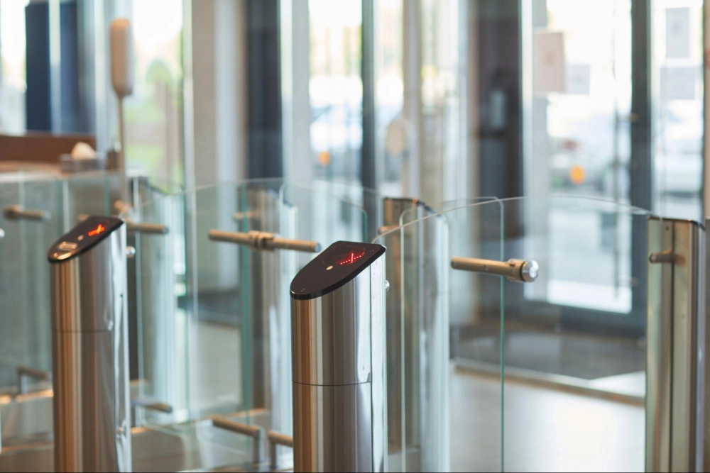 Modern access control security turnstile system at a secure building entrance, managed by American Security Force.