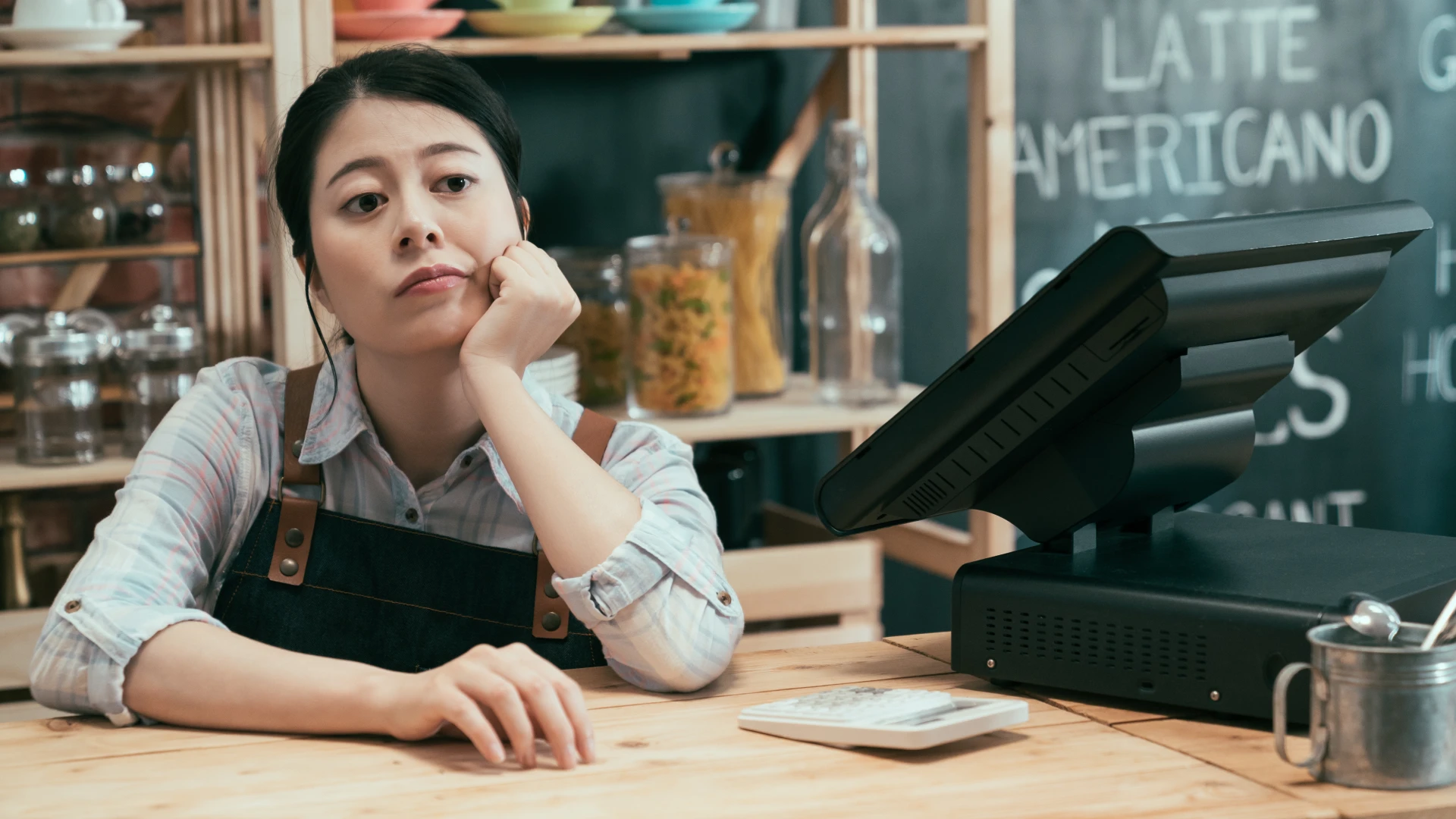 Employee theft risk in small retail business with distracted cashier at point of sale counter