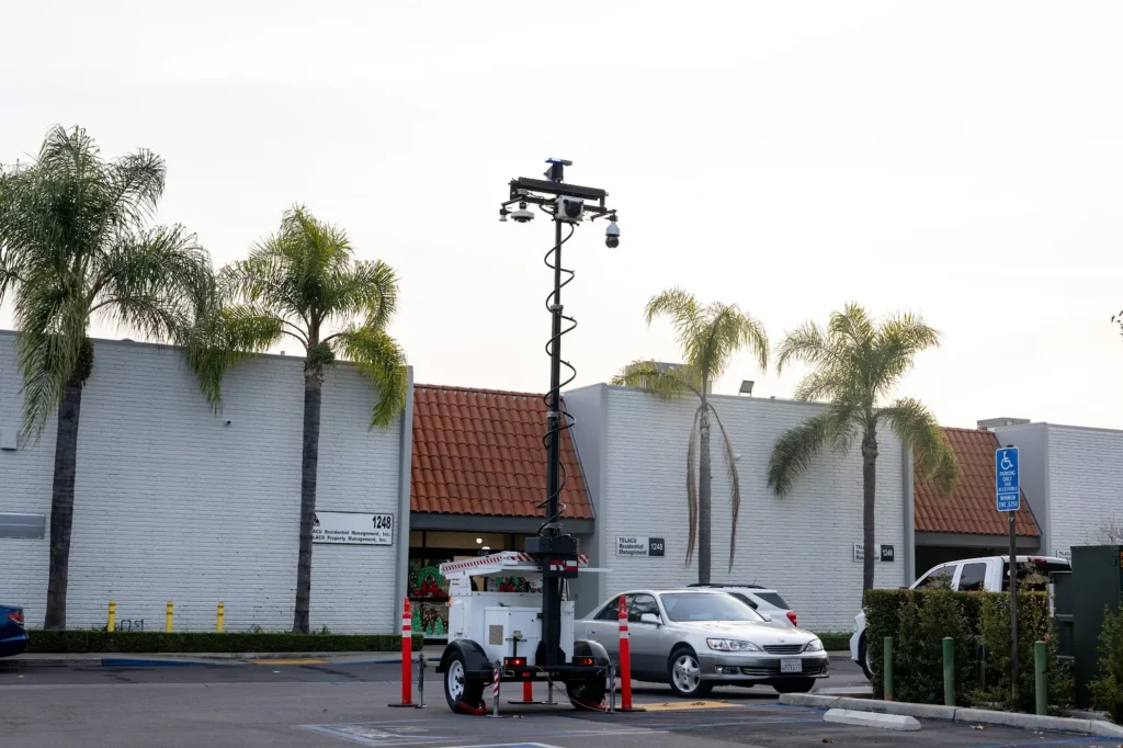 Parking Lot Surveillance Trailer Security | American Security Force Mobile Monitoring Solutions Mobile surveillance trailer with security cameras monitoring a commercial parking lot by American Security Force