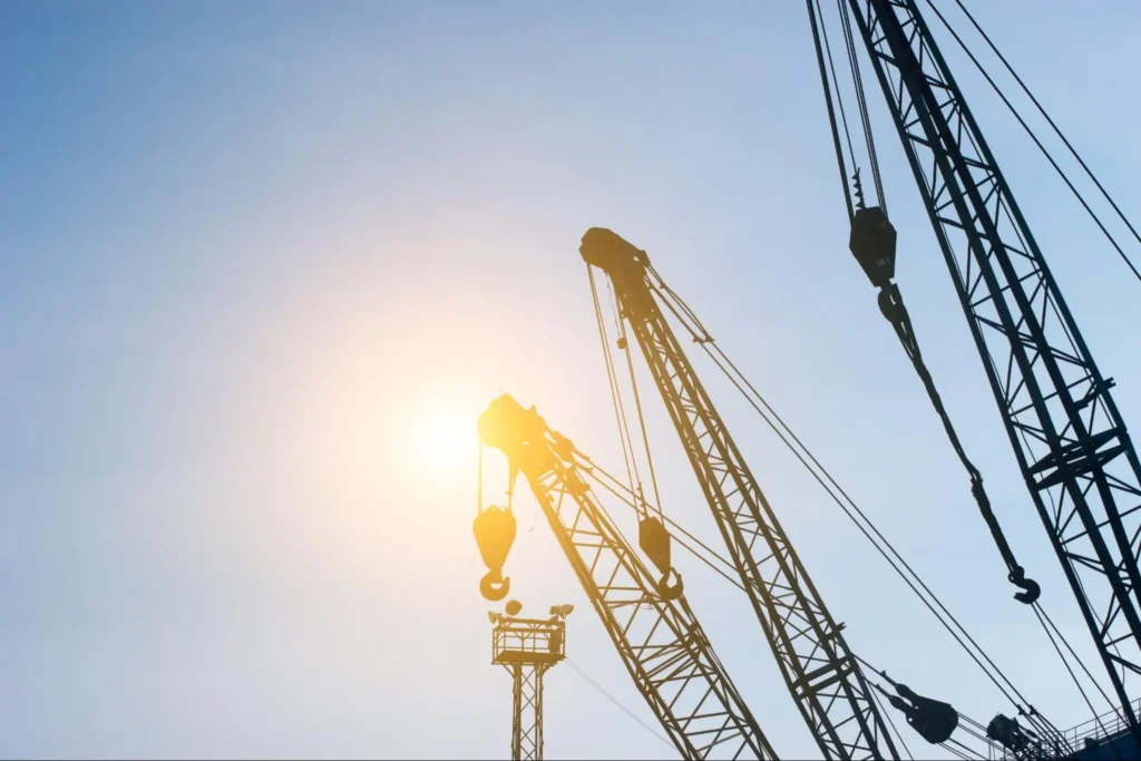 Construction site with cranes and surveillance equipment for jobsite security by American Security Force