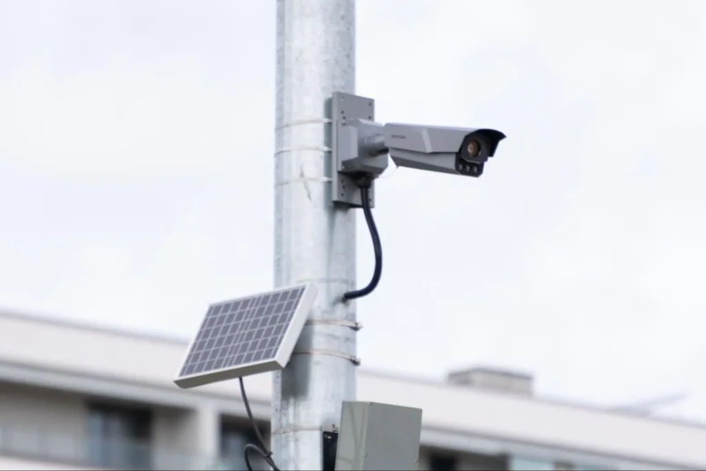 Solar-powered security camera mounted on a pole for outdoor surveillance by American Security Force